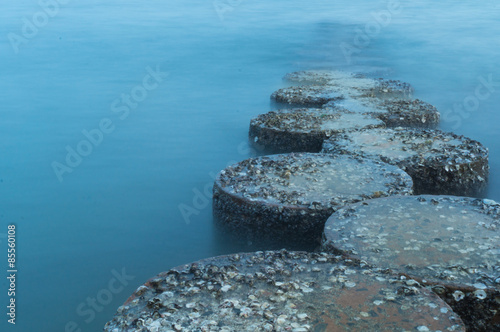 row of stones stepping on the sea