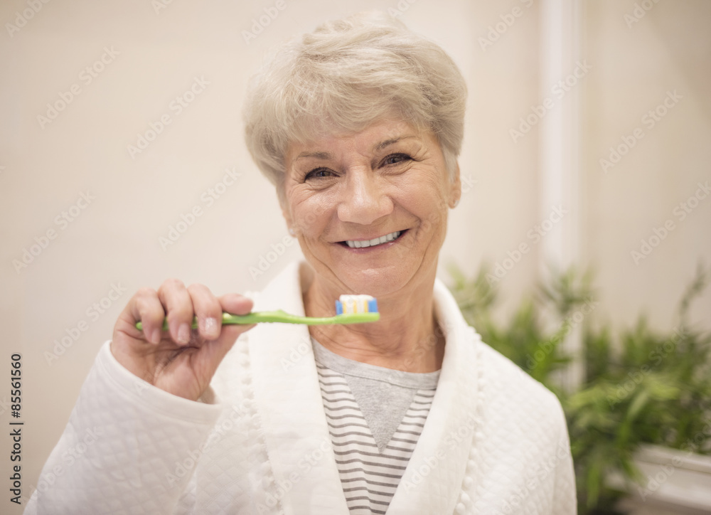 Senior woman brushing her teeth