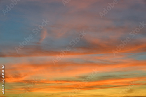 Sunset sky with orange colored clouds.   