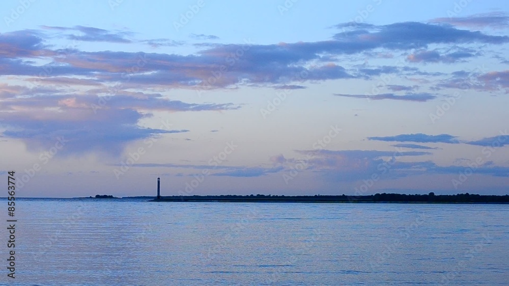 Tern flies at sunset with beautiful clouds and lighthouse Tern flies at sunset with beautiful clouds and lighthouse