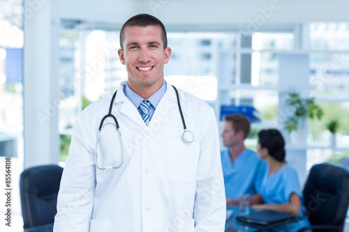 Handsome smiling doctor looking at camera 