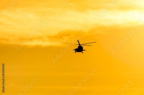 Mi-8 helicopter in the background of the golden sky