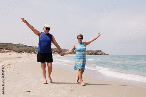 senior couple walking on the beach