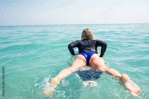 Woman with a surfboard on a sunny day