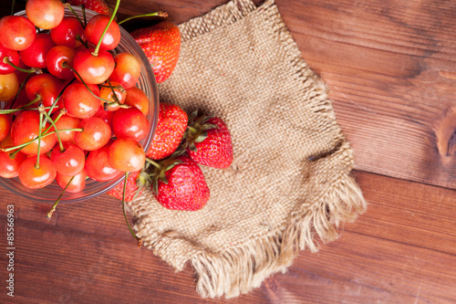 juicy rainier cherries and strawberry on linen napkin
