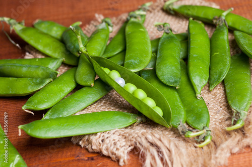 peas on wooden desk with a pearl