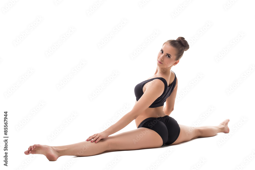 Handsome girl posing while doing gymnastic split Handsome girl posing while doing gymnastic split