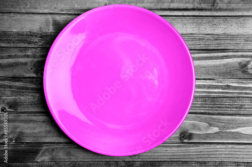 Pink plate on wooden table