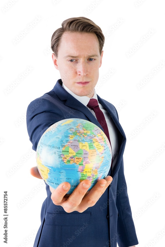 Serious businessman holding terrestrial globe Serious businessman holding terrestrial globe