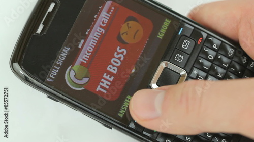 Ignore Boss Calling - Video of a handheld cellphone with incoming call from an angry boss getting ignored