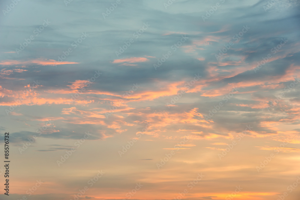 Sunset sky with orange colored clouds.
