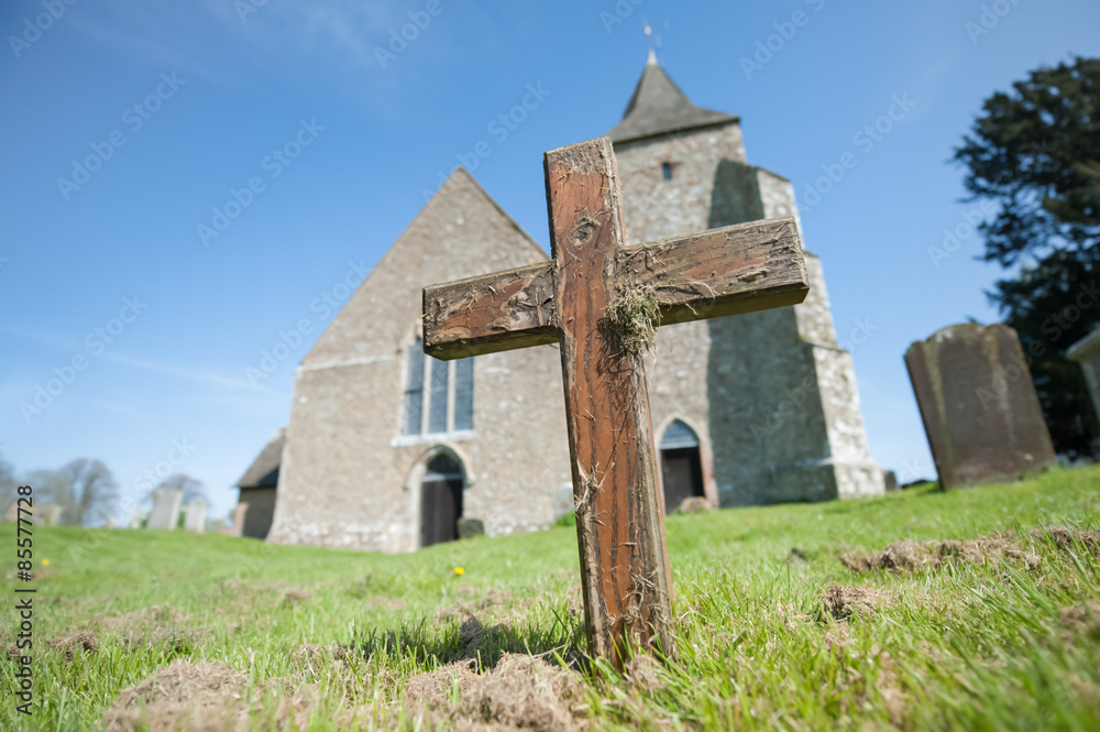 rugged wooden cross in a graveyard