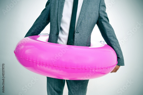 businessman with a pink swim ring, with a slight vignette added