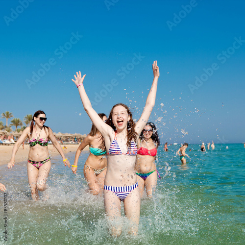 Girls running along the beach © dina777
