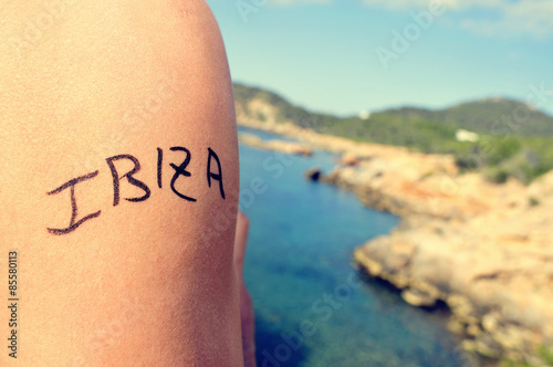 young man with the word Ibiza written in his arm photo