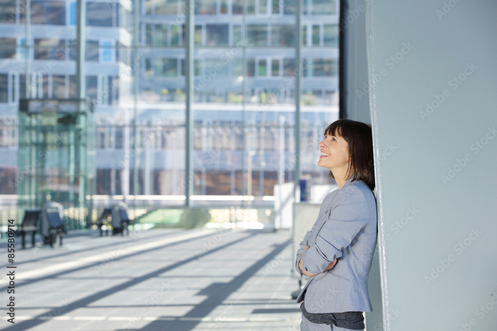 Happy business woman standing alone Happy business woman standing alone