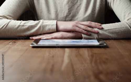 woman looking at screen digital tablet over wooden table