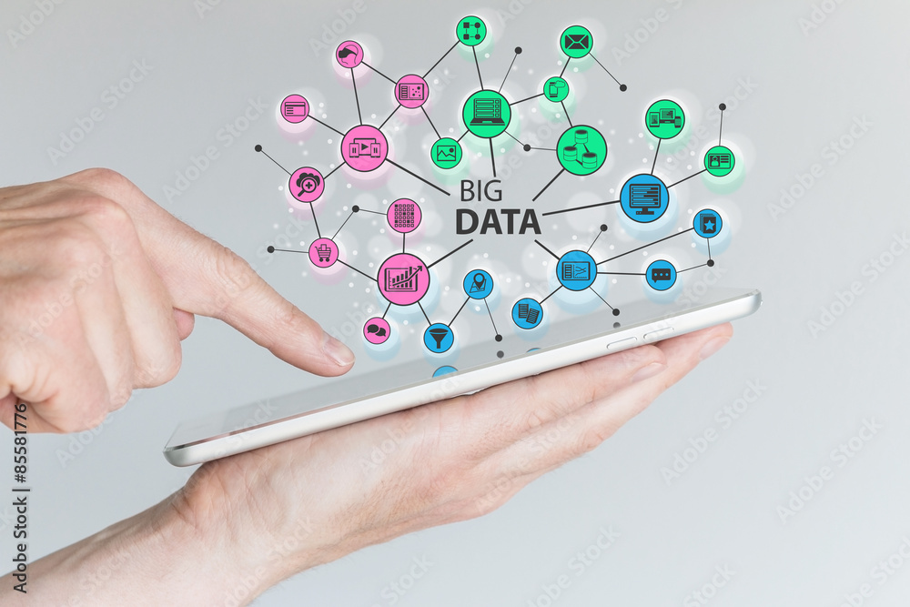 Big data and mobile computing concept. Hand holding silver tablet or smart phone Big data and mobile computing concept. Hand holding silver tablet or smart phone