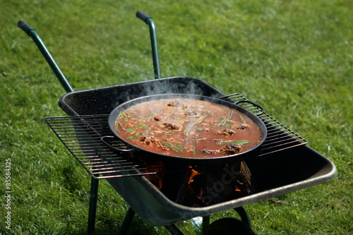 Paella being cooked on a barbecue