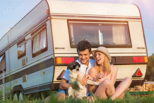 Young couple with a camper van photo