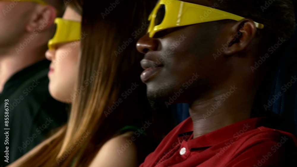 young people watching movie at movie theater, close up young people watching movie at movie theater, close up
