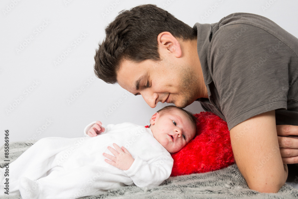 Loving father cuddling his new born baby