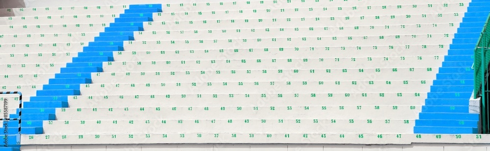 Obraz premium numbered bleachers with seats in soccer stadium