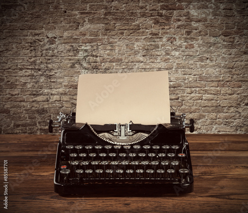 Vintage typewriter on wooden table photo