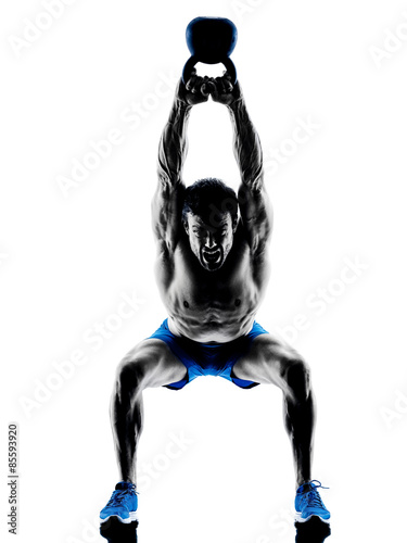 Fototapeta man exercising fitness Kettle Bell weights exercises silhouette