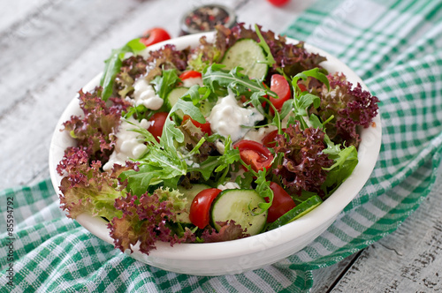 Useful dietary salad with cottage cheese, herbs and vegetables