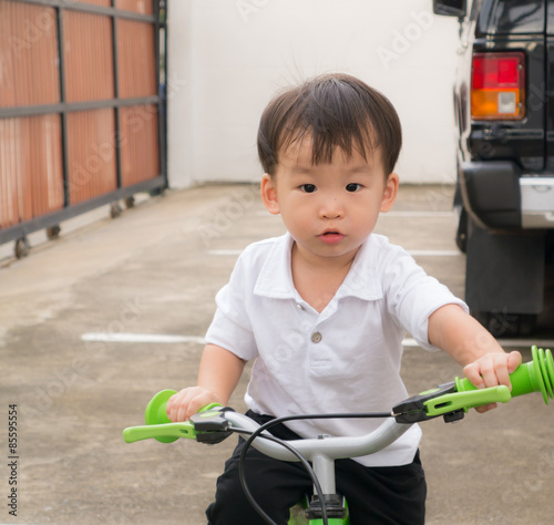 Asian little boy on a bike