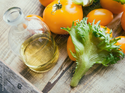 Components for salad: tomatoes, frillis and oil. photo