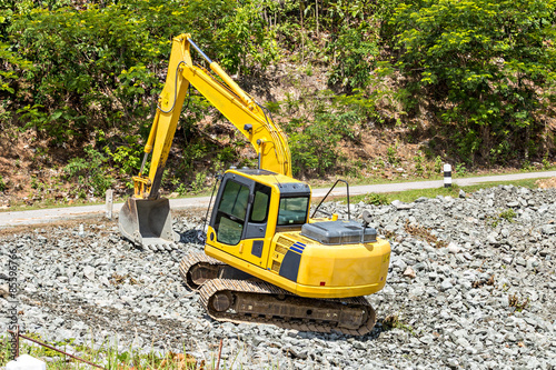 excavator digging rock on constriction site