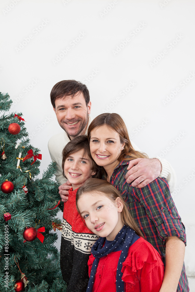 Family beside the christmas tree