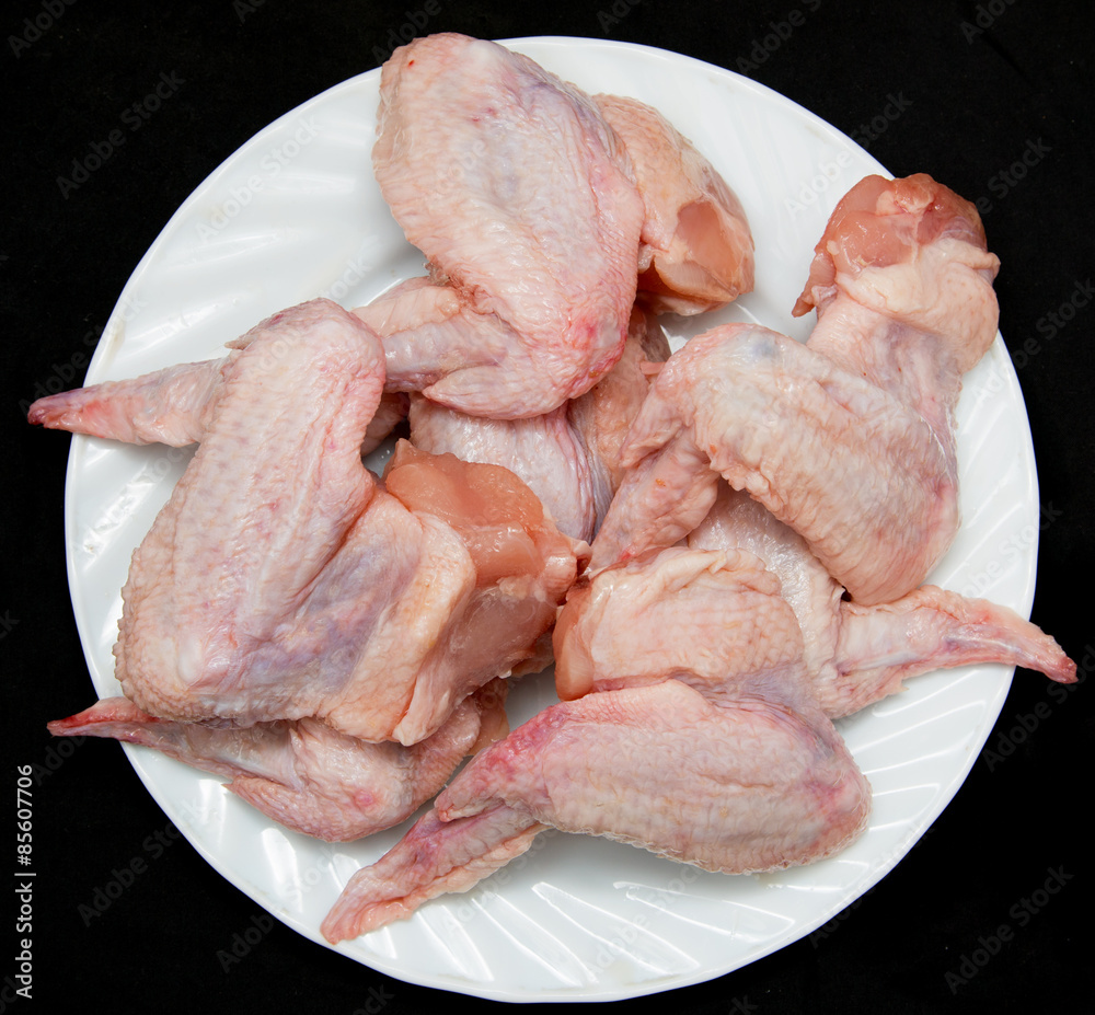Fresh chicken wings on a black background Fresh chicken wings on a black background
