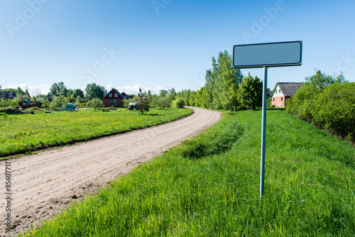 empty road with sign for village name