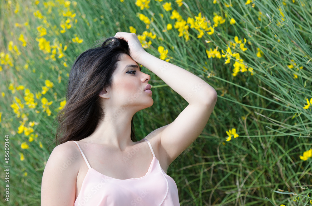 Cute Greek girl standing front of yellow bush Cute Greek girl standing front of yellow bush