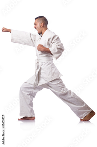 Karate fighter isolated on the white © Elnur