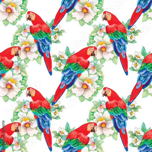 Watercolor parrots on a floral background. Seamless pattern.