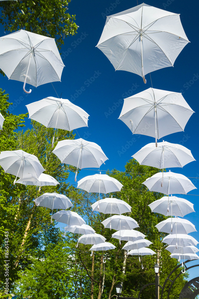 White umbrellas canes in the sky