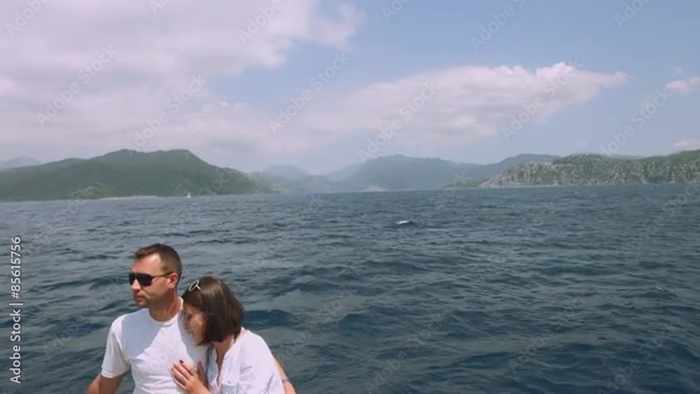 Couple in love on a yacht at sea. Boat traveling on the islands Couple in love on a yacht at sea. Boat traveling on the islands