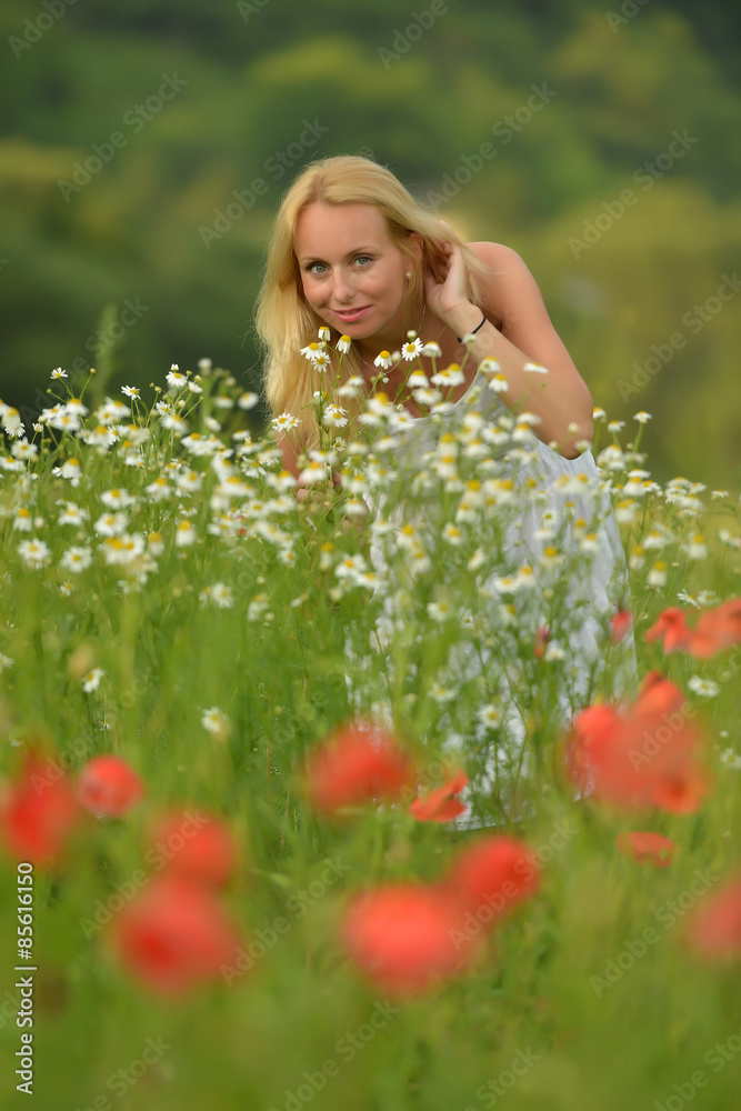 Pregnant happy woman in a flowering poppy field outdoors Pregnant happy woman in a flowering poppy field outdoors