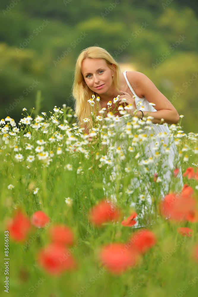 Pregnant happy woman in a flowering poppy field outdoors Pregnant happy woman in a flowering poppy field outdoors