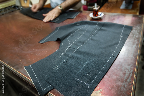 Fotografía Tailors table with fabric for a jacket marked up for sewing.