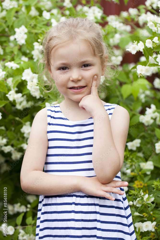 Close up portrait of a six year little girl, against background