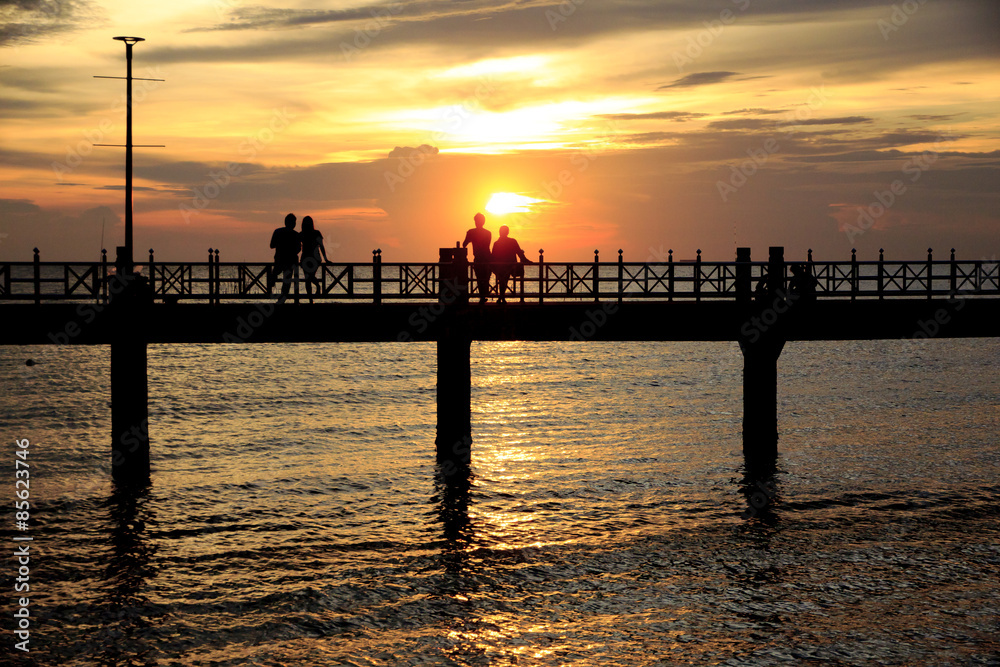 Stock Photo - People silhouettes on the sunset Stock Photo - People silhouettes on the sunset