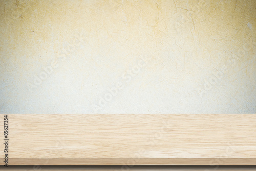 Empty wooden table over grunge cement wall  vintage  background  template  display