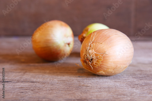 Organic Onions on Wooden Background.