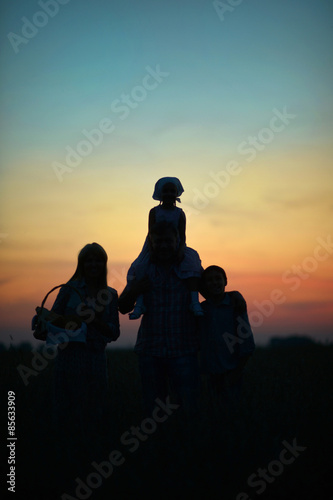 Family having rest in field