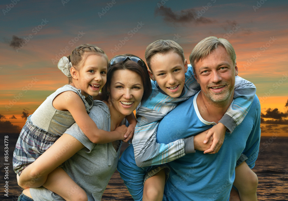 Friendly family on a background of a sunset Friendly family on a background of a sunset